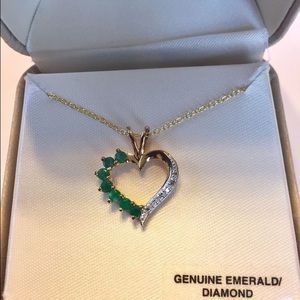 Emerald, diamond, and gold pendant.