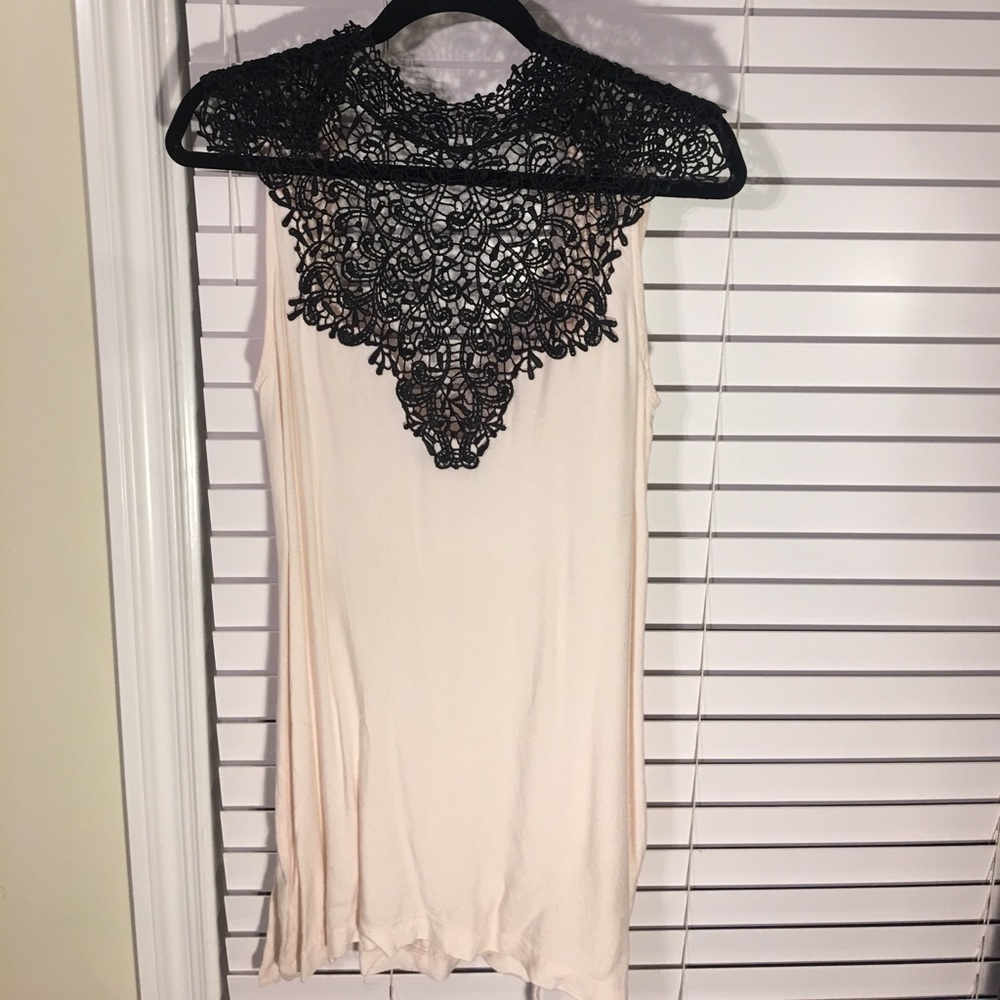 Elegant cream dress with black lace neck detail