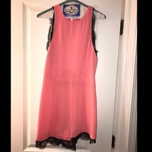 Pink romper with black lace trim