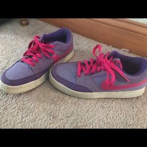 Pink and purple Nike tennis shoes