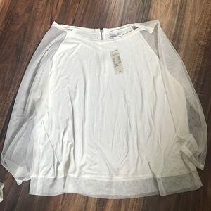 Cream top with zipper back and mesh sleeves.