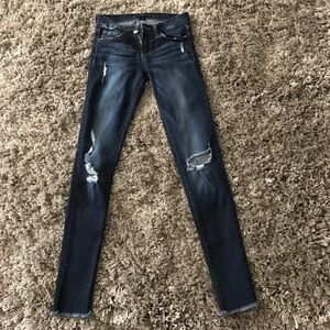 Women's distressed, skinny, dark wash jeans