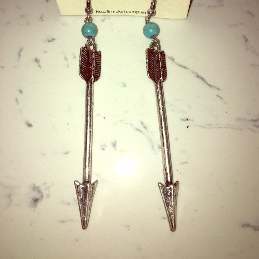Silver arrow long hanging earrings.