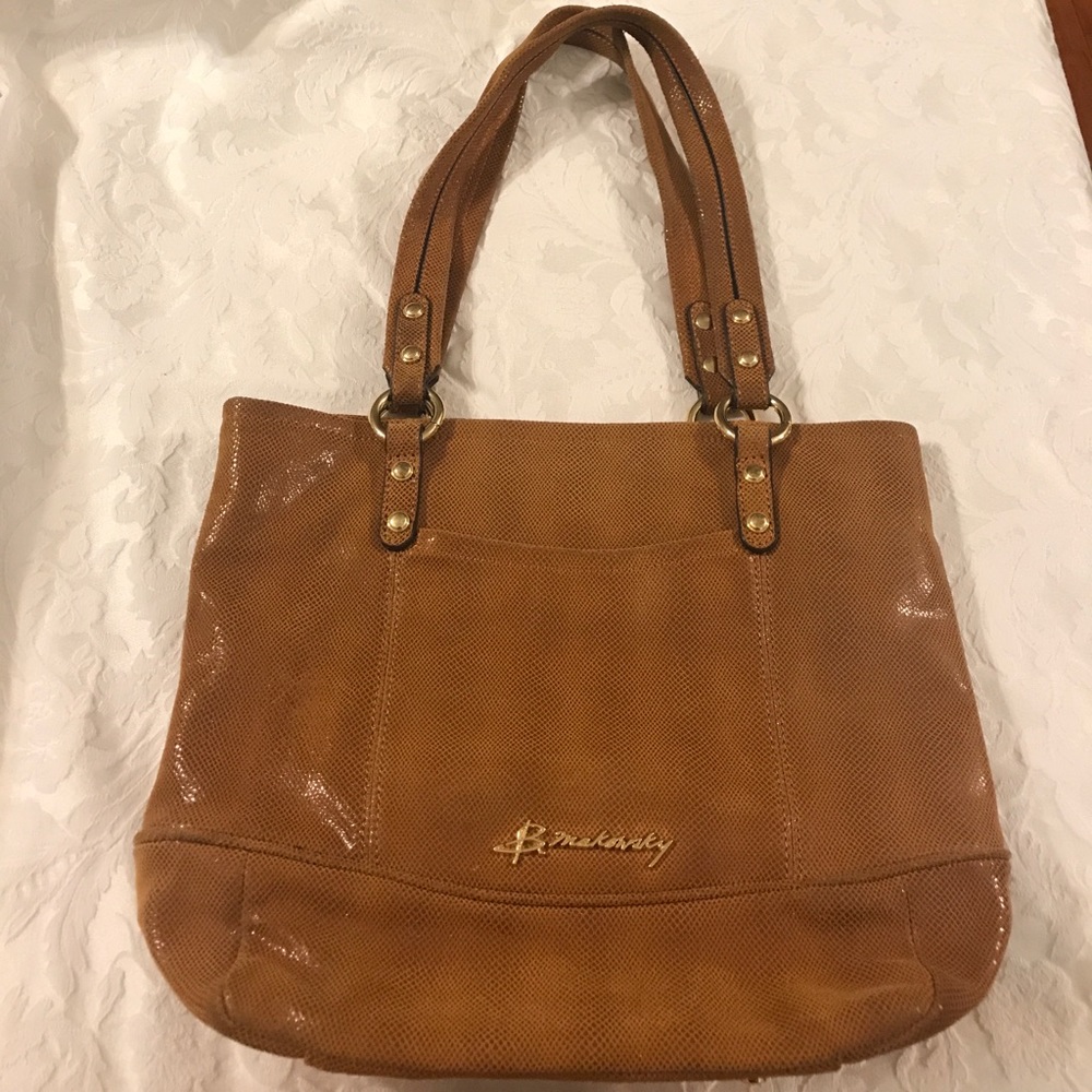 B. Makowsky brown leather handbag.