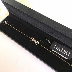 Nadri bow shaped dainty gold tone stones bracelet