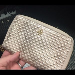 Tory Burch rose gold wristlet.