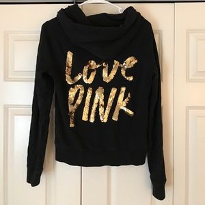 A PINK Victoria Secret zip up hoodie.