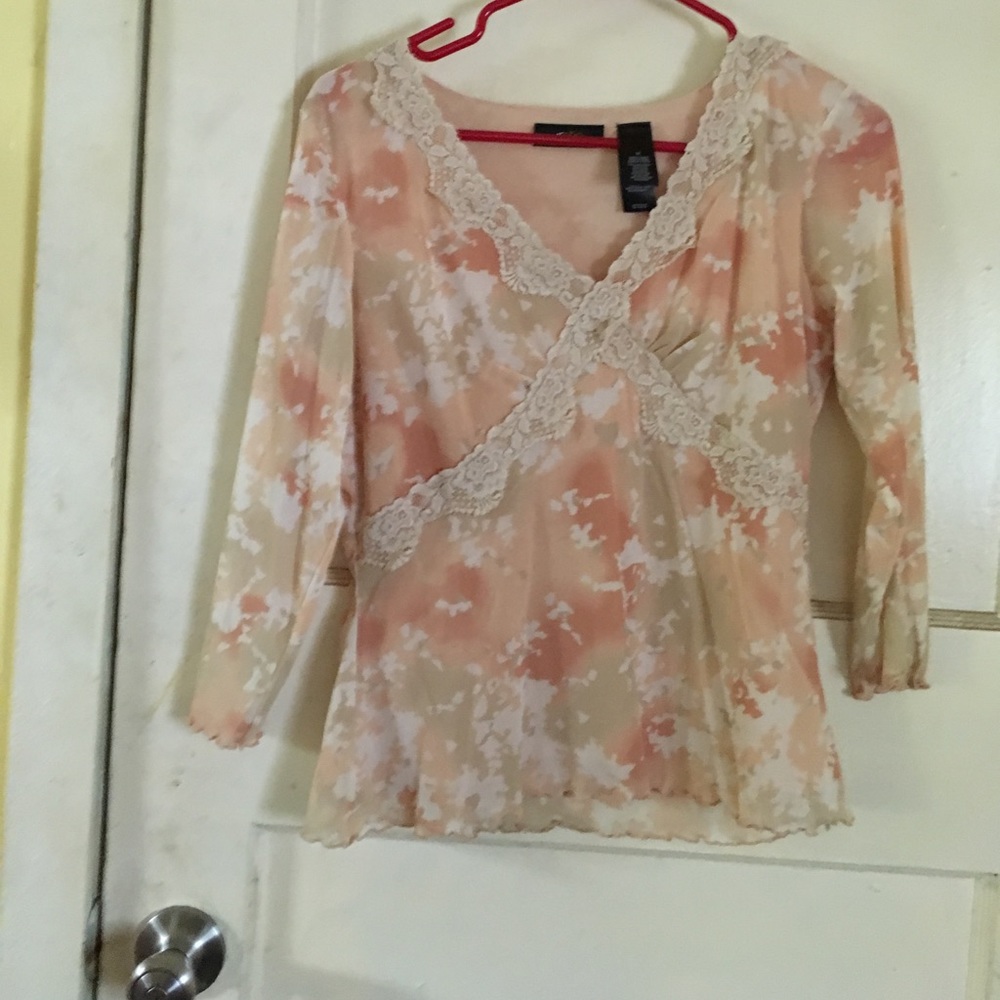 Pastel pink shirt with pastel flowers.