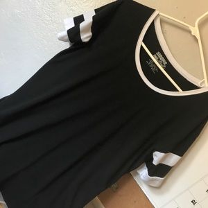 Black shirt with white on the sleeves and collar