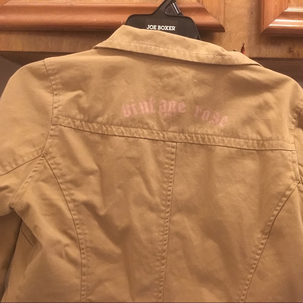 Tan jacket with pink stitching