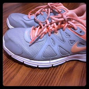 grey and pink Nike shoes