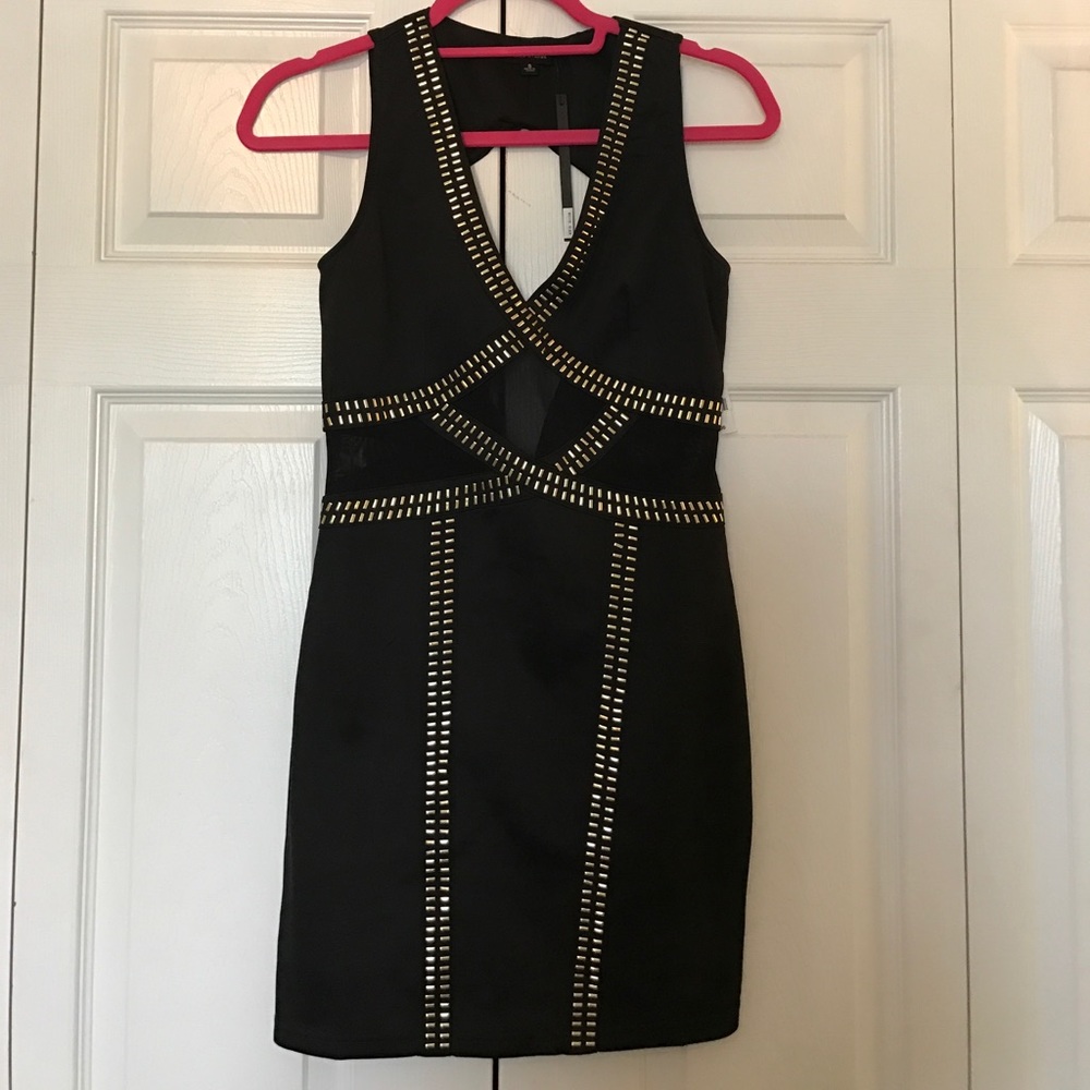 Black bodycon dress with gold metal accents