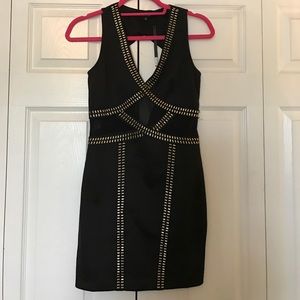 Black bodycon dress with gold metal accents