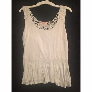 White peplum tank with lace looking back