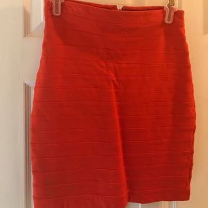 An orange high waisted pencil skirt