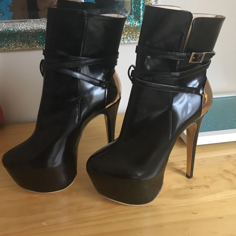 Black platform booties with gold accents