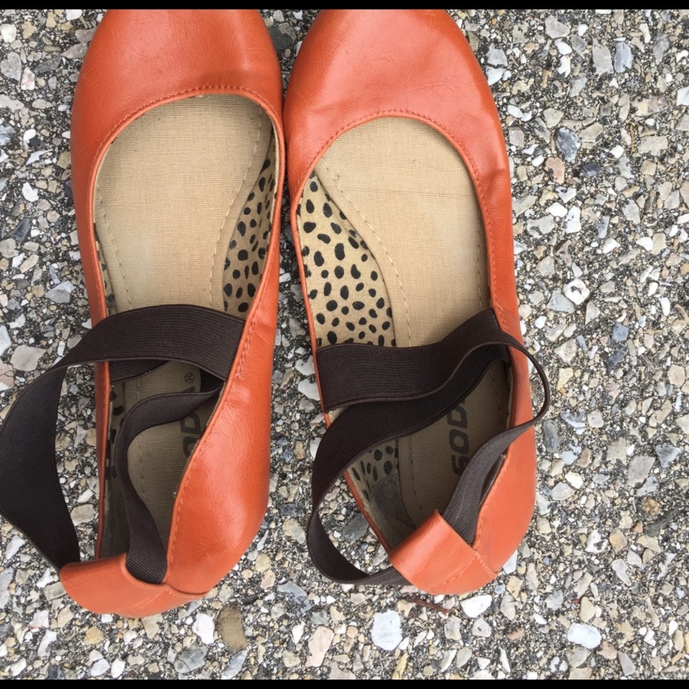 Orange rust soda flats with ankle straps.