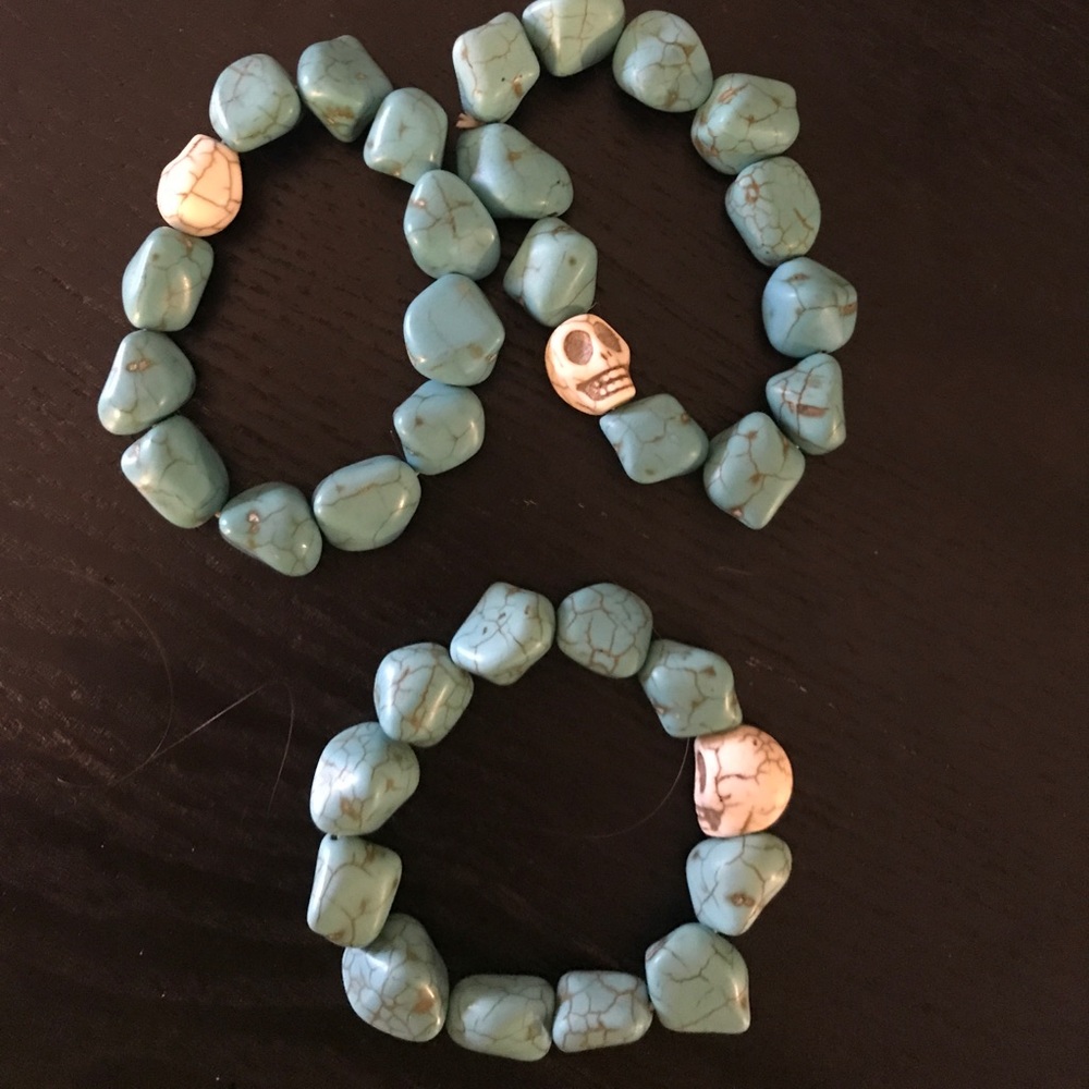 A set of 3 turquoise bracelets with skulls
