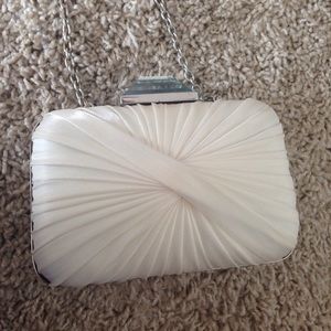 Sondra Roberts Cream clutch with blue-gray gem