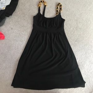 Black dress with gold chains in the straps