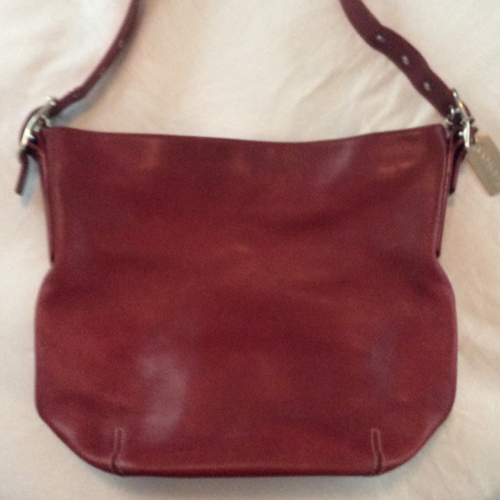 Small red leather coach shoulder bag.
