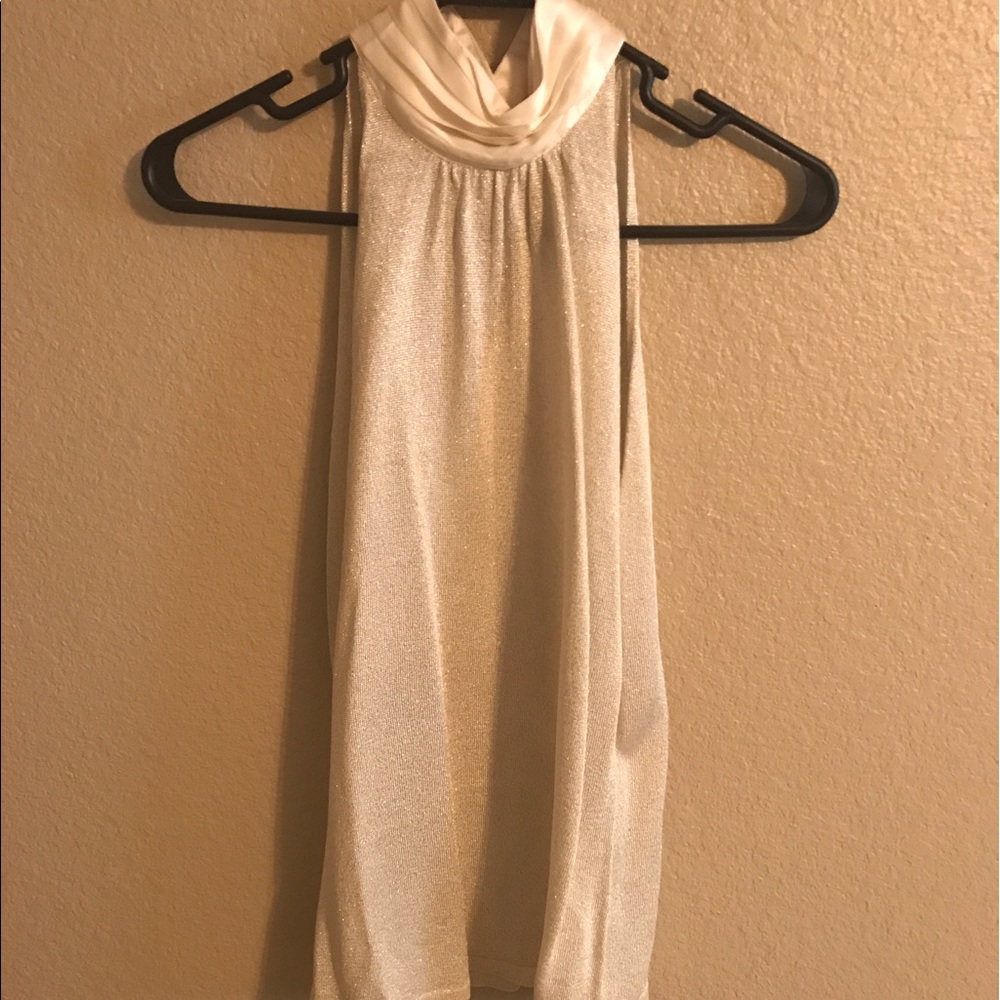 Chic gold metallic top with pearl neckline.