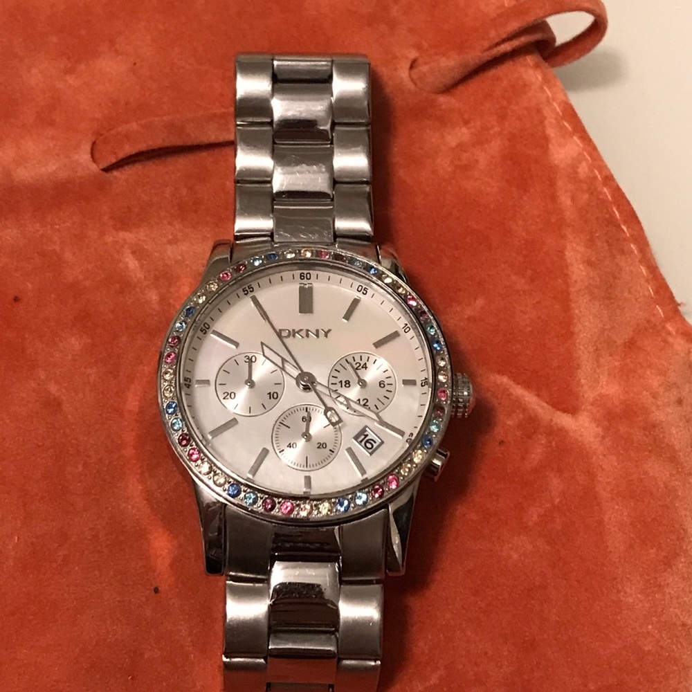 DKNY watch with multi colored crystals on face.