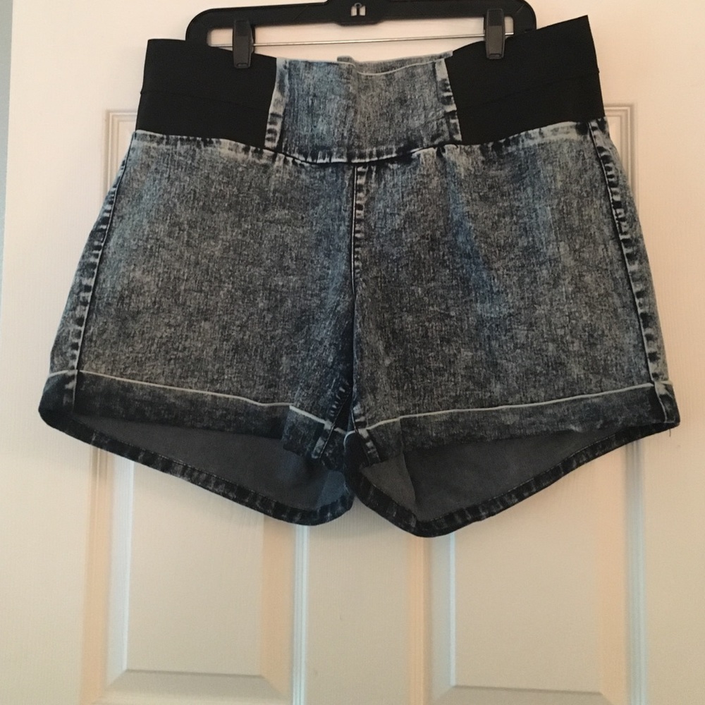 Acid wash denim shorts with elastic on sides.