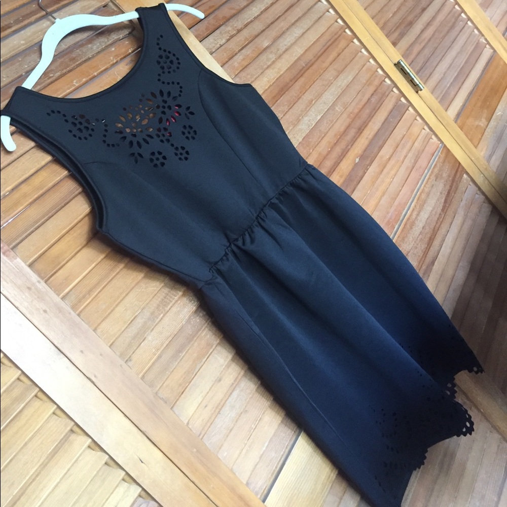 Simple sleeveless black dress, stencil cut details