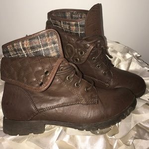 Brown combat boots with a plaid interior.