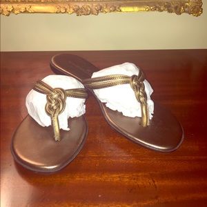 Bronze with gold accent thong style sandal.