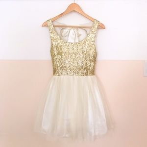 A mini gold sequin and eggshell dress