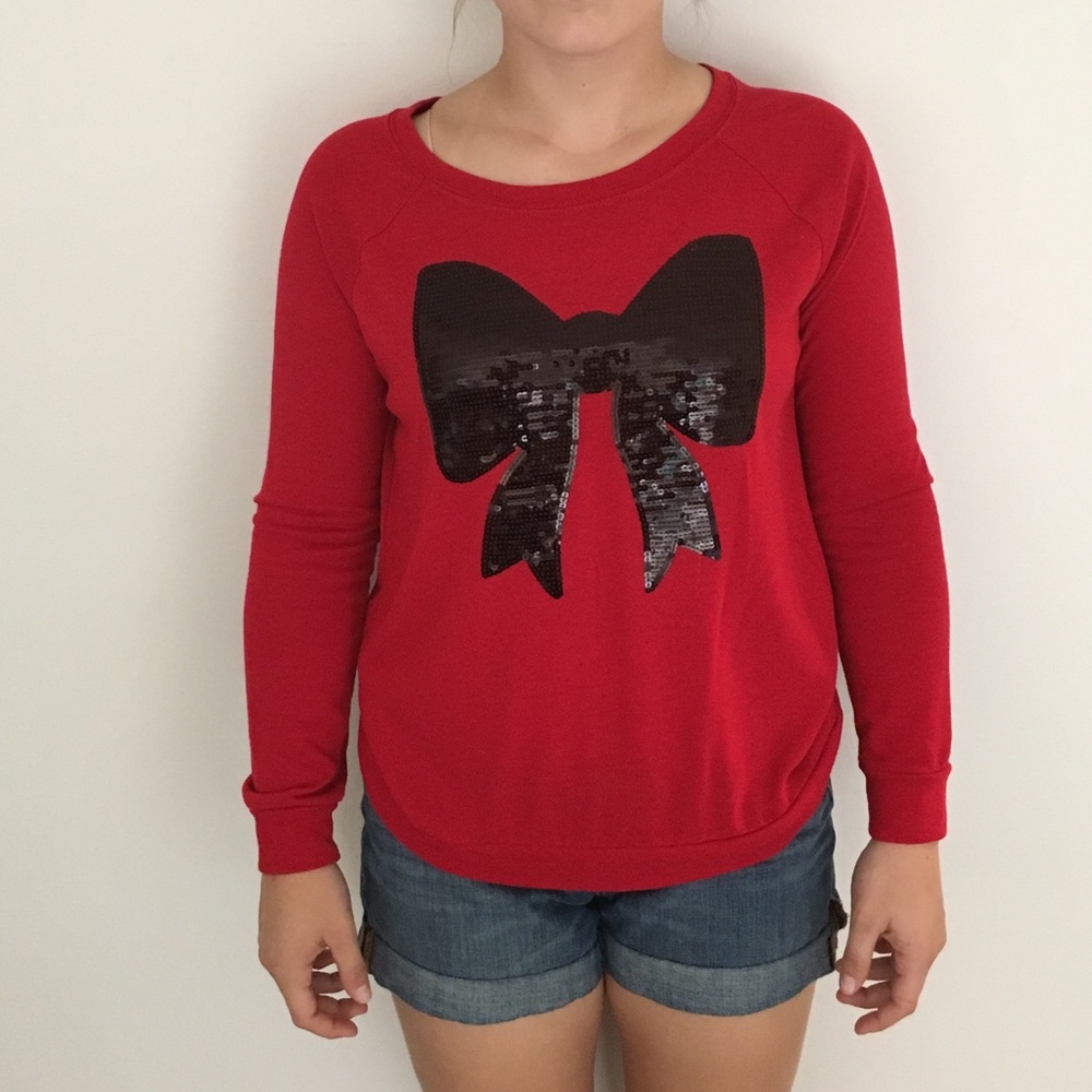 red long sleeved shirt with black sequin bow