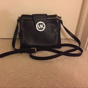 Michael Kors cross body purse with gold accidents