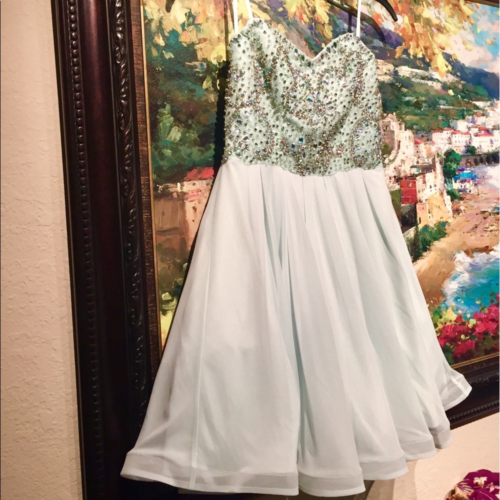 Jasmine blue dress adorned in embellishments.