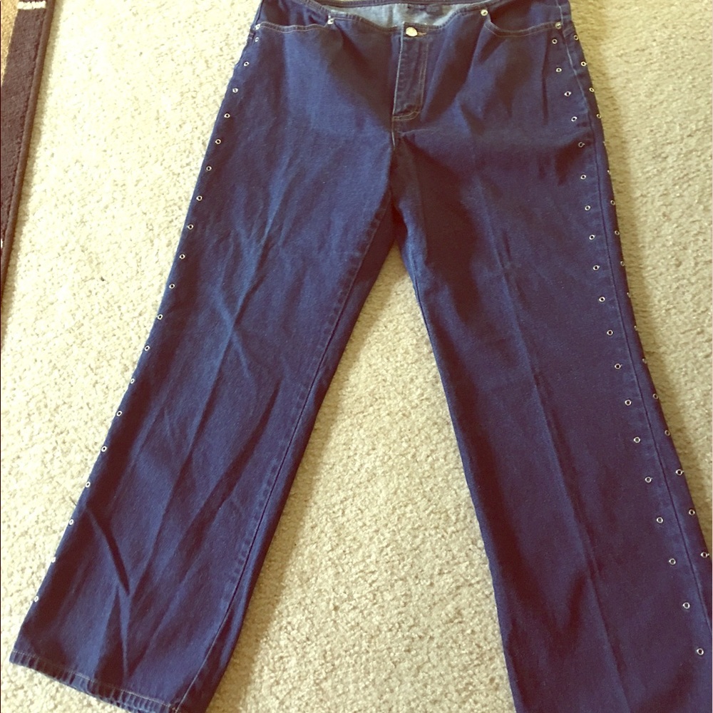 Fashionable denim jeans with open rivets