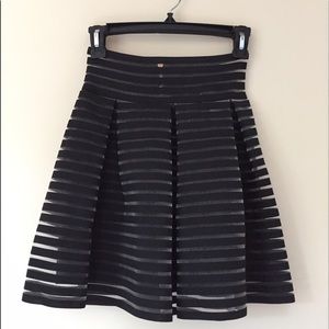 Mesh lined skater skirt featuring a zip up back.