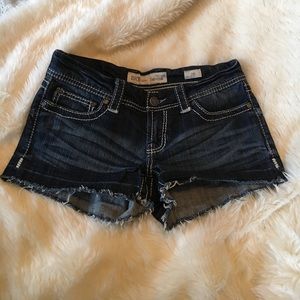 Denim shorts with frayed edge and distressing.