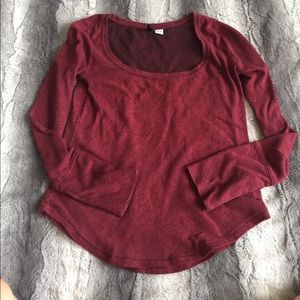 Maroon long-sleeved wide neck shirt.