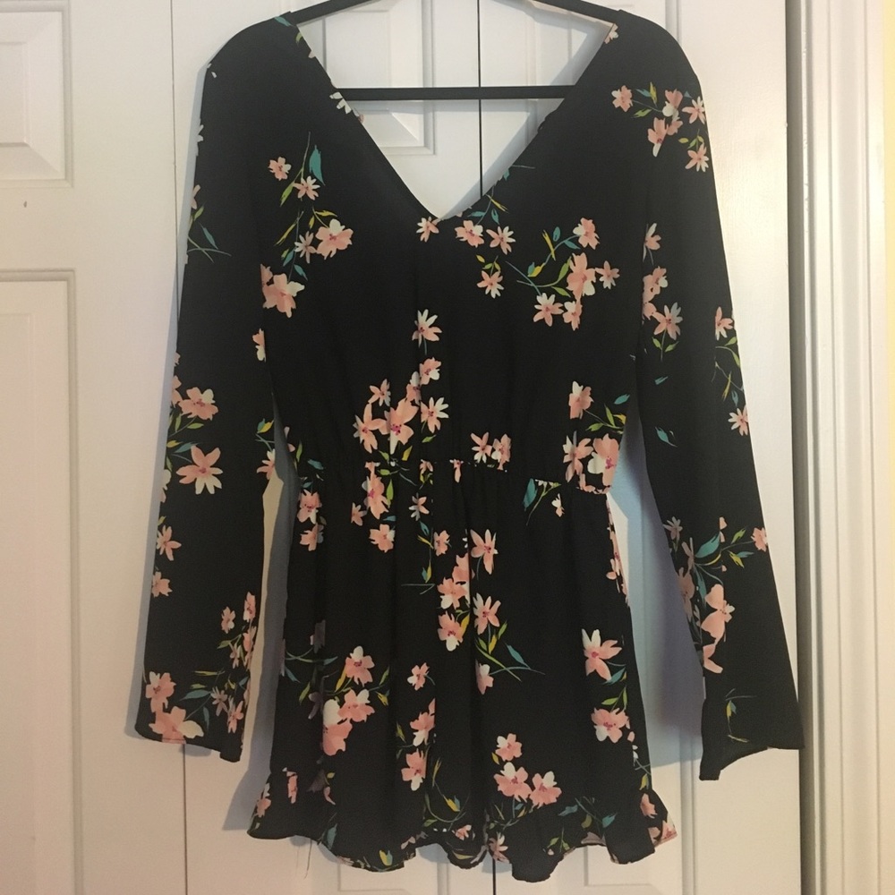 Black long-sleeve romper with flowers.