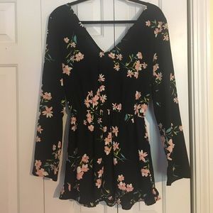 Black long-sleeve romper with flowers.