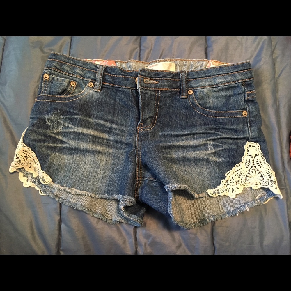 Size 9 denim shorts with lace accents.