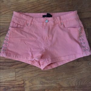 Pink studded jean shorts