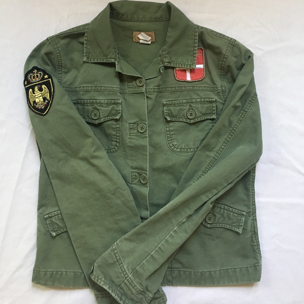 Green army jacket with patches.