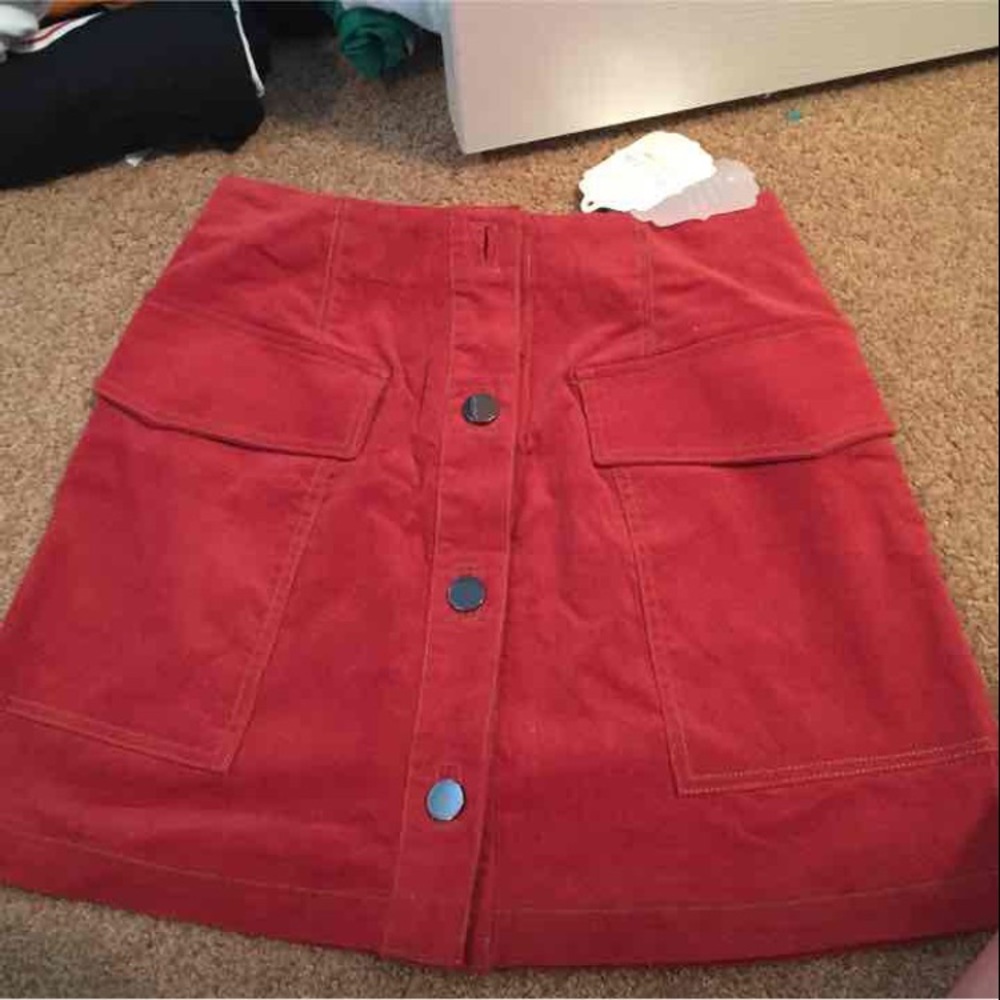 Light red skirt with dark silver buttons
