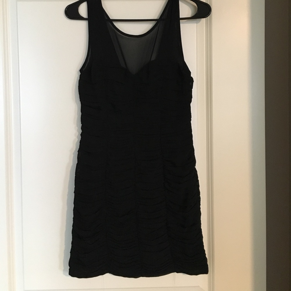 Black form-fitting mini dress with mesh top