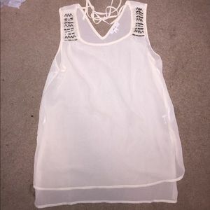 Thin cream colored cover tank, string ties in back