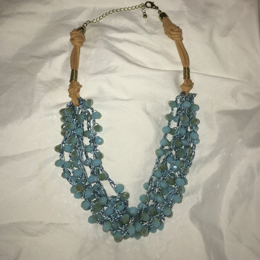 blue bead necklace with tan leather detail