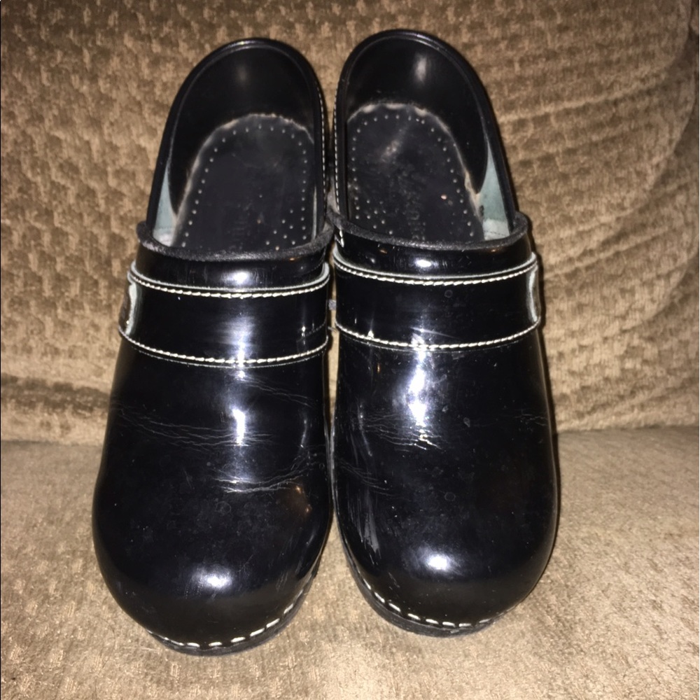Black patent Koi Sanita clogs.