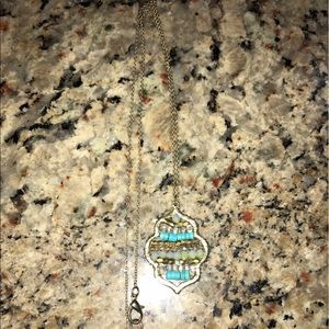 Long necklace with jade- beaded emblem